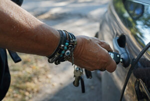 HIppie Capitalist Opens Car Door